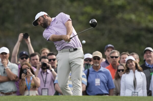 Scottie Scheffler hits his tee shot on the 10th hole during a practice round in preparation for the Masters golf tournament at Augusta National Golf Club Wednesday, April 10, 2024, in Augusta, GA. (AP Photo/Charlie Riedel)