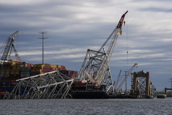 The collapsed Francis Scott Key Bridge lays on top of the container ship Dali, Thursday, April 25, 2024, in Baltimore. (AP Photo/Matt Rourke)