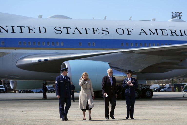 FILE - President Joe Biden, center right, and first lady Jill Biden, center left, walk off Air Force One, March 29, 2024, at Andrews Air Force Base, Md. The White House and the Democratic National Committee are splitting the cost of Biden’s travel while he runs for a second term. It’s part of a longstanding arrangement that prevents taxpayers from being stuck with the full bill for political trips. (AP Photo/Alex Brandon, File)