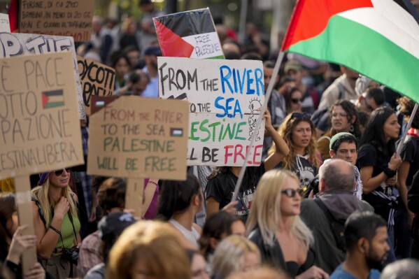 FILE - Protesters gather for a pro-Palestinian demonstration, in Rome, Saturday, Oct. 28, 2023. The Jordan River is a winding, 200-plus-mile run to the east of Israel and the West Bank. The sea is the glittering Mediterranean to its west. But a phrase about the space in-between, “from the river to the sea,” has become a battle cry with new power to roil Jews and pro-Palestinian activists in the aftermath of Hamas’ murderous rampage across southern Israel Oct. 7 and Israel’s bombardment of Gaza. (AP Photo/Andrew Medichini, File)