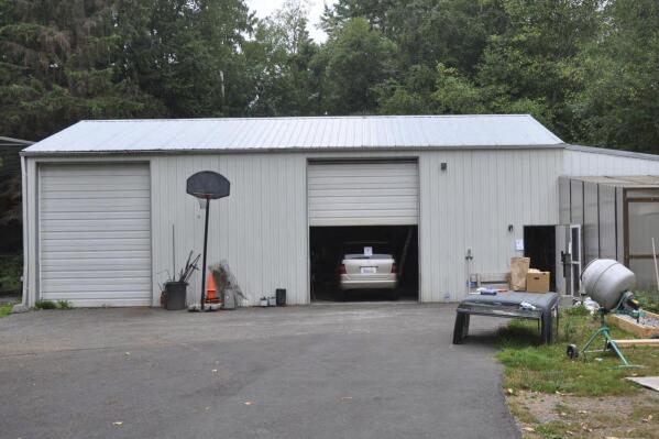 In this photo provided by the U.S. Attorney's Office is the exterior of a workshop owned by Bradley Woolard, 42, who ran a significant fentanyl pill-pressing operation from the property in Arlington, Wash., on Aug. 16, 2018. Authorities said Woolard and his right-hand man, Anthony Pelayo, 35, of Marysville, Wash., had ordered enough supplies to make 2.5 million make around 2.5 million fentanyl-laced pills before they got caught in 2018. Woolard was sentenced to 20 years in prison on Tuesday, Nov. 30, 2021. Pelayo was sentenced to 15 years on Nov. 23, 2021. (Martin Weinbaum/Snohomish County Sheriff's/U.S. Attorney's Office via AP)