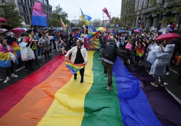 People take part in the European LGBTQ pride march in Belgrade, Serbia, Saturday, Sept. 17, 2022. Serbian police have banned Saturday's parade, citing a risk of clashes with far-right activists. (AP Photo/Darko Vojinovic)