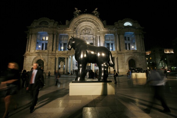 FILE - A statue by Colombian artist Fernando Botero stands outside the Fine Arts Palace during the inauguration of Botero's retrospective exhibit titled "Fernando Botero: a celebration" in Mexico City, March 29, 2012. Botero died on Sept. 15, 2023 in Monaco, according to his daughter Lina Botero who confirmed his passing to Colombian radio station Caracol. (AP Photo/Marco Ugarte, File)