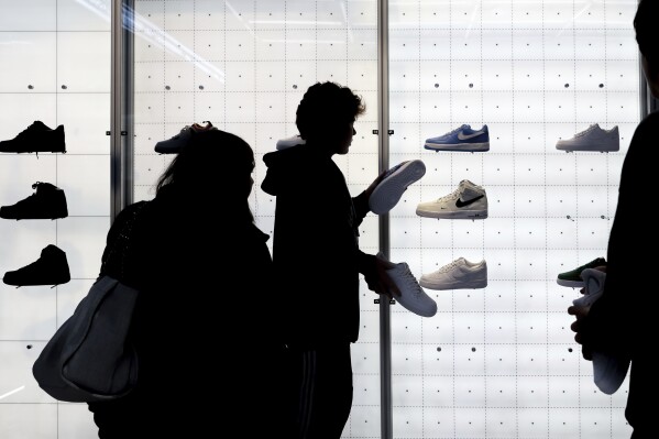 People shop for shoes in a Nike store on Nov. 25, 2022, in New York. (AP Photo/Julia Nikhinson, File)