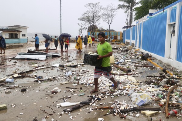 A walks through debris after Hurricane Erick hit near Puerto Escondido, Oaxaca state, Mexico, Thursday, June 19, 2025. (AP Photo/Luis Alberto Cruz)