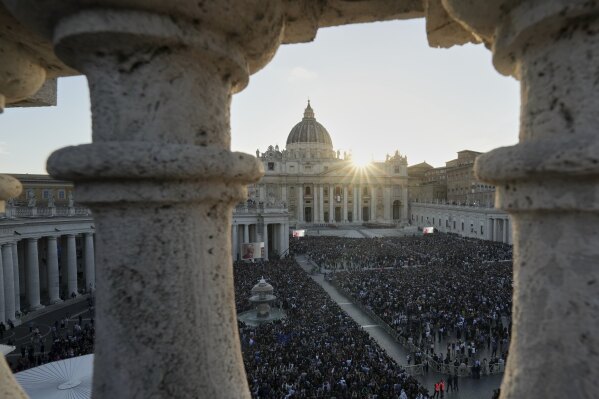 Crowds wait for Pope Leo XIV to appear on the balcony of St Peter's Basilica after his election, at the Vatican, Thursday, May 8, 2025. (AP Photo/Antonio Calanni)