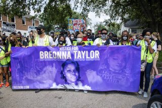 FILE - Protesters participate in the Good Trouble Tuesday march for Breonna Taylor, on Tuesday, Aug. 25, 2020, in Louisville, Ky.  A lawyer for Breonna Taylor's family said a plea deal was offered to an accused drug trafficker that would have forced him to implicate Taylor, who was killed by police in a raid on her home in March. Louisville's top prosecutor acknowledged the existence of the document but said it was part of preliminary plea negotiations with a man charged with illegal drug trafficking and not an attempt to smear Taylor.(Amy Harris/Invision/AP File)