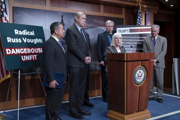Sen. Patty Murray, D-Wash., speaks as Sen. Ben Ray Lujan, D-N.M., from left, Sen. Sen. Jeff Merkley, D-Ore., Sen. Alex Padilla, D-Calif., obstructed, Sen. Sheldon Whitehouse, D-R.I., and Sen. Tim Kaine, D-Va., listen during a news conference on Russ Vought's nomination at the Capitol in Washington, Thursday, Jan. 30, 2025. (AP Photo/Jose Luis Magana)