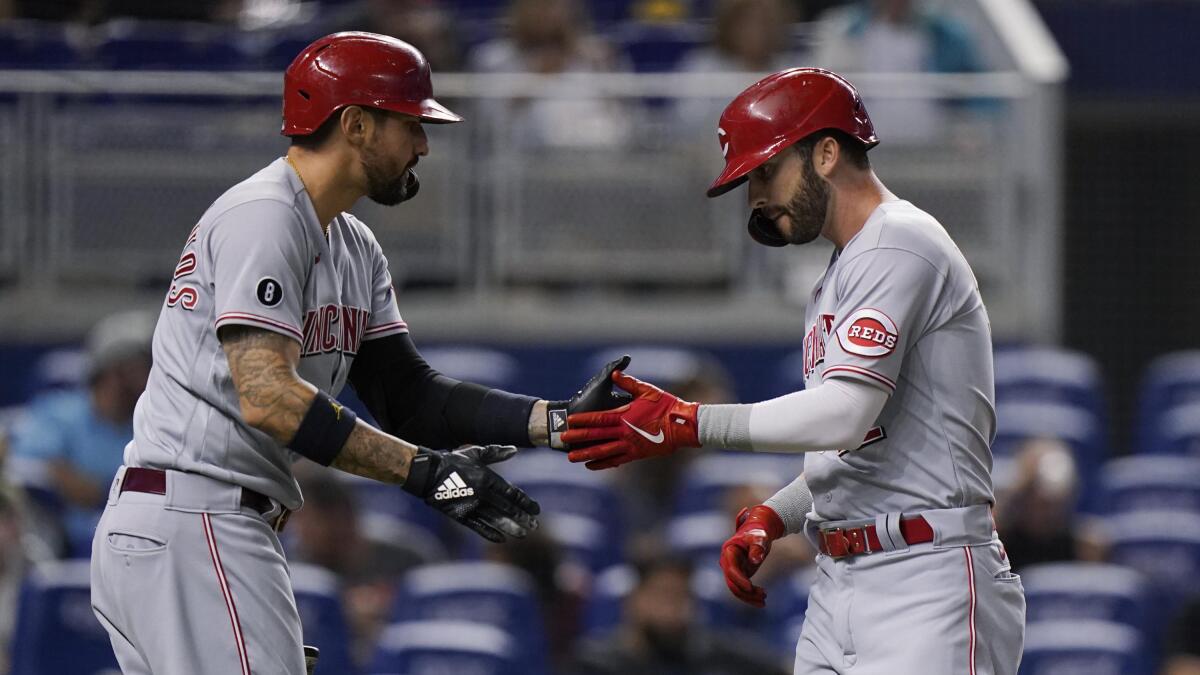 Miley goes 7, Naquin extends streak, Reds beat Marlins 6-0