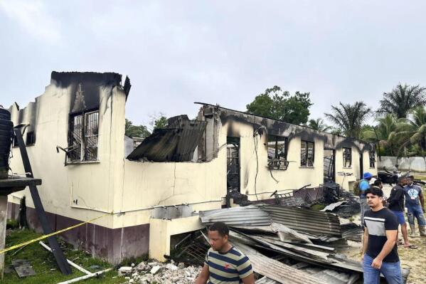 FILE - In this photo provided by Guyana's Department of Public Information, the dormitory of a secondary school is burned in Mahdia, Guyana, Monday, May 22, 2023. A government commission in Guyana tasked with investigating a fire that killed 20 children at an Indigenous boarding school found multiple errors and systematic failures, Friday, Jan. 19, 2024. (Guyana's Department of Public Information via AP, File)