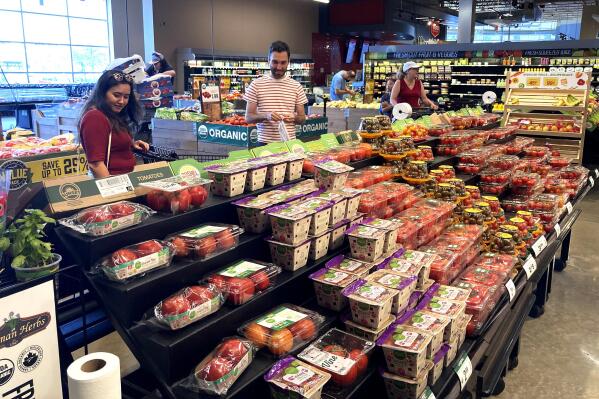 Shoppers shop at a grocery store in Glenview, Ill., Monday, July 4, 2022.  U.S. demand for grocery delivery is cooling as food prices rise. Some shoppers are shifting to less expensive grocery pickup, while others are returning to the store. (AP Photo/Nam Y. Huh)