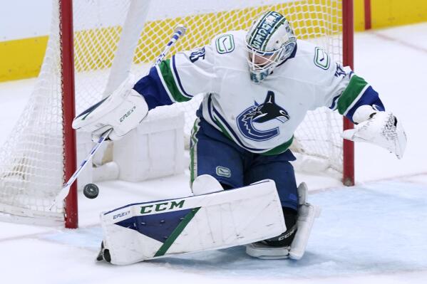 Vancouver Canucks goaltender Thatcher Demko turns away a shot during the first period of the team's NHL hockey game against the Dallas Stars in Dallas, Saturday, March 26, 2022. (AP Photo/LM Otero)