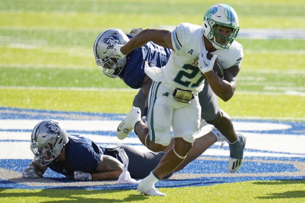 Tulane running back Makhi Hughes, right, rushes during the first half of an NCAA college football game against Rice, Saturday, Oct. 28, 2023, in Houston. (AP Photo/Eric Christian Smith)