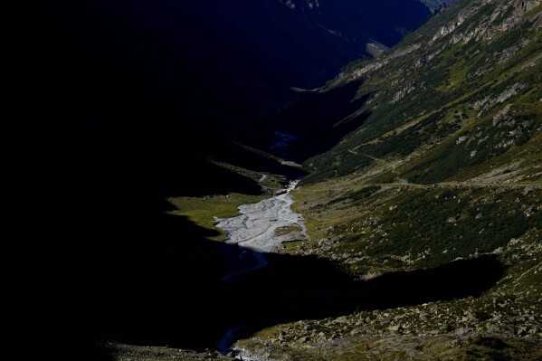 Glacier water spews out of the valley at the Jamtalferner Glacier near Galtuer, Austria, Tuesday, Sept. 5, 2023. (AP Photo/Matthias Schrader)