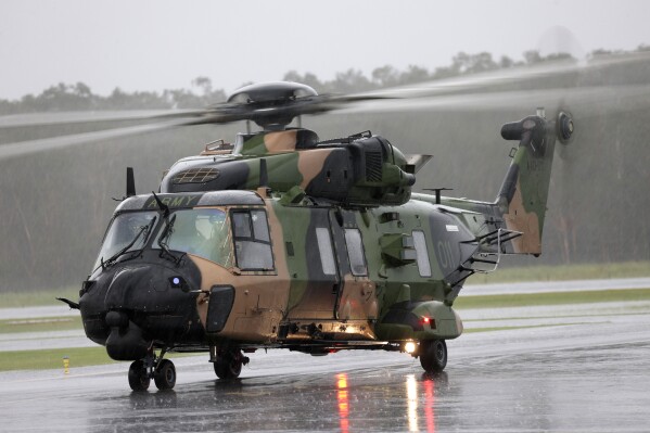 In this photo provided by the Australian Defence Force an Australian Army MRH-90 Taipan helicopter from the School of Army Aviation prepares to take off from Ballina airport, Ballina, Australia, Feb 27, 2022, during Operation Flood Assist 2022. Four air crew were missing after an Australian Army helicopter ditched into waters off the Queensland state coast during joint U.S.-Australian military exercises, officials said on Saturday, July 29, 2023. (Mr Bradley Richardson/ADF via AP)