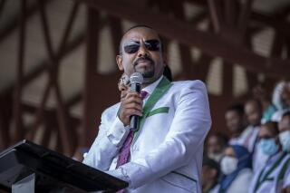 FILE - Ethiopia's Prime Minister Abiy Ahmed speaks at a final campaign rally at a stadium in the town of Jimma in the southwestern Oromia Region of Ethiopia, Wednesday, June 16, 2021 . Facebook says it has removed a post by Abiy Ahmed that urged citizens to rise up and “bury” the rival Tigray forces who now threaten the capital as the country’s war reaches the one-year mark.. (AP Photo/Mulugeta Ayene, File)