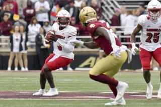 Louisville's quarterback Malik Cunningham eyes a receiver during the first half of an NCAA college football game against Boston College, Saturday, Oct. 1, 2022, in Boston. (AP Photo/Mark Stockwell)