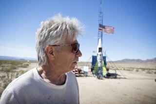 FILE - In this March 6, 2018, file photo, "Mad" Mike Hughes reacts after the decision to scrub another launch attempt of his rocket near Amboy, Calif. The self-styled daredevil died Saturday, Feb. 22, 2020, after a rocket in which he launched himself crashed into the ground, a colleague and a witness said.  (James Quigg/Daily Press via AP, File)