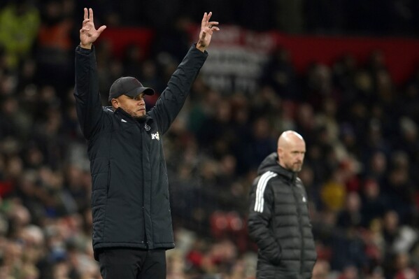 FILE - Burnley manager Vincent Kompany gestures to his players during the English League Cup fourth round soccer match against Manchester United, at Old Trafford in Manchester, England, Wednesday, Dec. 21, 2022. Racism has long permeated the world’s most popular sport, with soccer players subjected to racist chants and taunts online. While governing bodies like FIFA and UEFA have taken steps to combat the abuse of players, the lack of diversity in the upper ranks at major clubs remains an unsolved problem. (AP Photo/Dave Thompson, File)