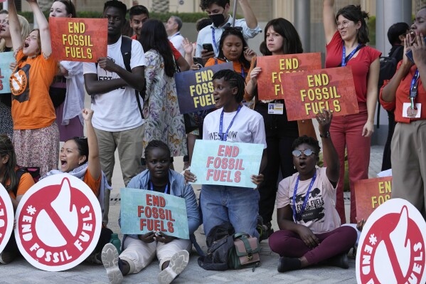 FILE - Vanessa Nakate, of Uganda, center, takes part in a protest against fossil fuels at the COP28 U.N. Climate Summit, Tuesday, Dec. 5, 2023, in Dubai, United Arab Emirates. (AP Photo/Rafiq Maqbool)