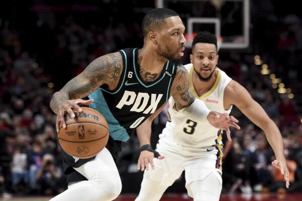 Portland Trail Blazers guard Damian Lillard, left, drives to the basket against New Orleans Pelicans guard CJ McCollum during the first half of an NBA basketball game in Portland, Ore., Wednesday, March 1, 2023. (AP Photo/Steve Dykes)