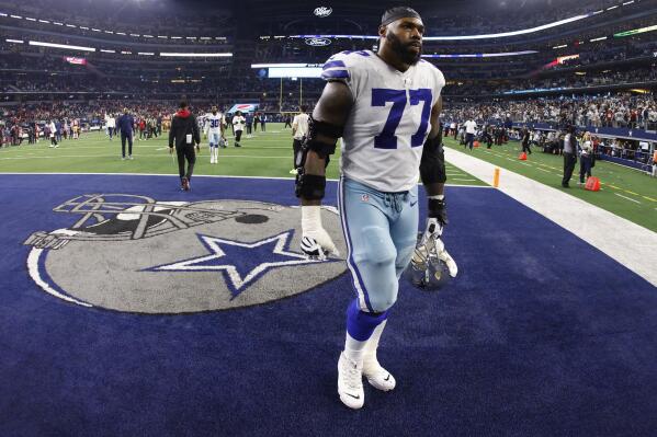 FILE - Dallas Cowboys offensive tackle Tyron Smith (77) leaves the field following an NFL wild-card playoff football game against the San Francisco 49ers in Arlington, Texas, Sunday, Jan. 16, 2022. Smith is expected to return at some point during the 2022-23 season after sustaining a torn left hamstring that also injured that knee. Owner and general manager Jerry Jones said Thursday, Aug. 25, 2022, that he wasn't sure if Smith's injury would require surgery, but that the eight-time Pro Bowler should return late in the season. (AP Photo/Ron Jenkins, File)