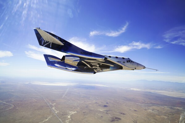 FILE - In this May 29, 2018 photo provided by Virgin Galactic, the VSS Unity craft flies during a supersonic flight test. Virgin Galactic is taking its first space tourists on a rocket ship ride after years of delays, including one passenger who bought his ticket 18 years ago and a mother-daughter duo from the Caribbean. (Virgin Galactic via AP, File)