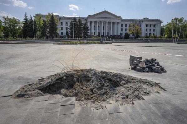 A crater in the aftermath of a Russian missile strike, in front of the city council hall building, in Kramatorsk city hall, eastern Ukraine, Saturday, July 16, 2022. Ukrainians living in the path of Russia's invasion in the besieged eastern Donetsk region are bracing themselves for the possibility that they will have to evacuate. (AP Photo/Nariman El-Mofty)