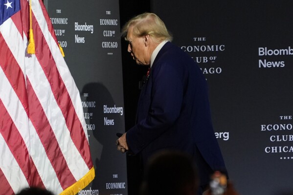 Republican presidential nominee former President Donald Trump walks off after an interview with Bloomberg News Editor-in-Chief John Micklethwait during an event with the Economic Club of Chicago, Tuesday, Oct. 15, 2024, in Chicago. (AP Photo/Evan Vucci)