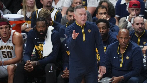 Denver Nuggets head coach Michael Malone, front, gestures during the first half of Game 5 of basketball's NBA Finals against the Miami Heat, Monday, June 12, 2023, in Denver. (AP Photo/Jack Dempsey)
