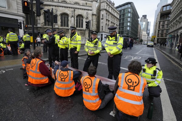 FILE - Activists from the group Just Stop Oil block a road in London, on Oct. 27, 2022 demanding to stop future gas and oil projects from going ahead. Britain said on Monday July 31, 2023 it will grant hundreds of new oil and gas licenses in the North Sea in a bid for energy independence, ignoring calls from the environmental campaigners and the United Nations to stop the development of new fossil fuel projects. (AP Photo/Kirsty Wigglesworth, File)
