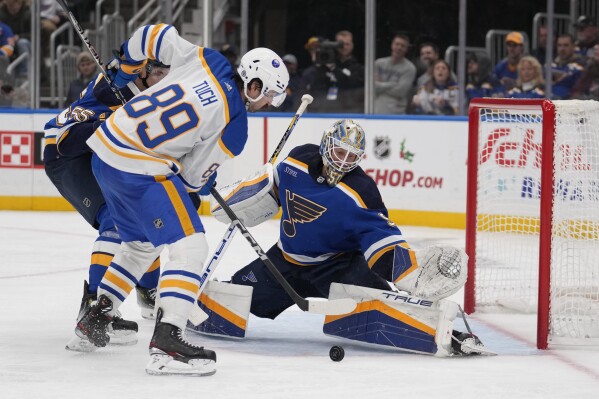 Buffalo Sabres' Alex Tuch (89) is unable to score past St. Louis Blues goaltender Jordan Binnington (50) during the third period of an NHL hockey game on Thursday, Nov. 30, 2023, in St. Louis. (AP Photo/Jeff Roberson)