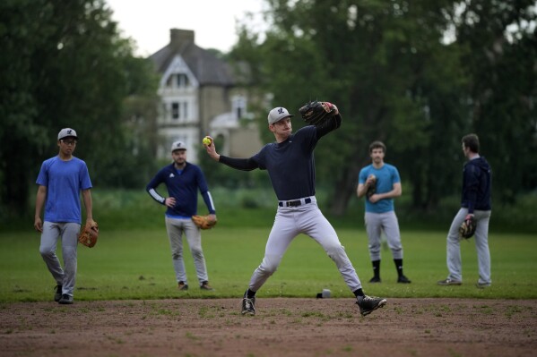 Members of the UK baseball team London Mets practice during a training session at the Finsbury Park in London, Thursday, May 16, 2024. Baseball at the highest club level in Britain is competitive. Teams are mélange of locals and expats some with college and minor league experience. (AP Photo/Kin Cheung)