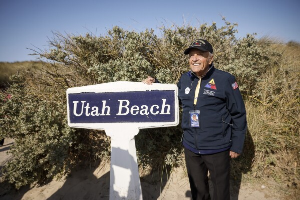 FILE - U.S. veteran Andrew Negra poses for a photo after the commemoration organized by the Best Defense Foundation at Utah Beach near Sainte-Marie-du-Mont, Normandy, France, Sunday, June 4, 2023, ahead of the D-Day Anniversary. French President Emmanuel Macron on Wednesday March 6, 2024 called on the public to collect photos, films, personal journals and testimony from witnesses to liberation at the end of World War Two, as the country prepares to mark the 80th anniversary of the Normandy landings which heralded the beginning of the end for Nazi Germany. (AP Photo/Thomas Padilla, File)