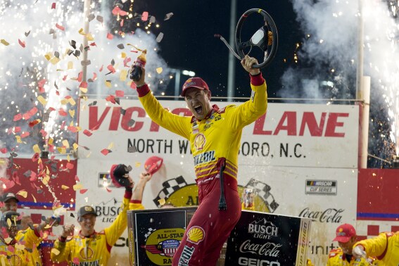 Joey Logano celebrates in Victory Lane after winning the NASCAR All-Star auto race at North Wilkesboro Speedway in North Wilkesboro, N.C., Sunday, May 19, 2024. (AP Photo/Chuck Burton)
