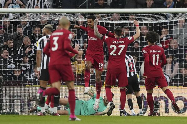Liverpool's Cody Gakpo, center, celebrates scoring against Newcastle United during the English Premier League soccer match at St. James' Park, Newcastle upon Tyne, England, Saturday Feb. 18, 2023. (Owen Humphreys/PA via AP)