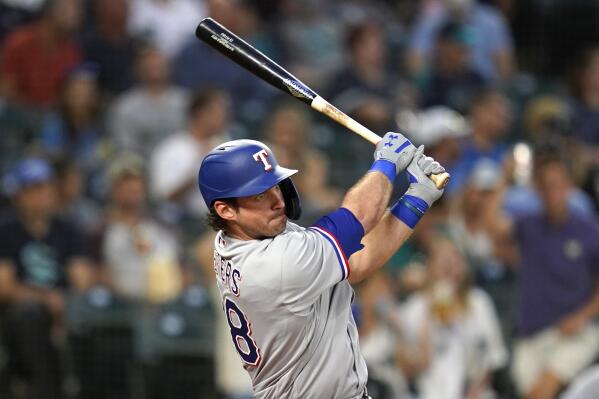 Texas Rangers' DJ Peters drives watches his RBI double against the Seattle Mariners during the fifth inning of a baseball game Tuesday, Aug. 10, 2021, in Seattle. (AP Photo/Elaine Thompson)