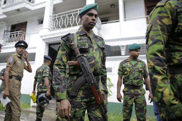 
              Sri Lankan security forces officers secure a site believed to be a hide out of the militants following a shoot out in Colombo, Sri Lanka, Sunday, April 21, 2019.  More than hundred were killed and hundreds more hospitalized with injuries from eight blasts that rocked churches and hotels in and just outside of Sri Lanka's capital on Easter Sunday, officials said, the worst violence to hit the South Asian country since its civil war ended a decade ago. (AP Photo/Eranga Jayawardena)
            
