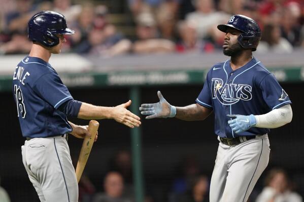 Tampa Bay Rays' Randy Arozarena, right, is congratulated by Joey Wendle after Arozarena scored in the 10th inning of the team's baseball game against the Cleveland Indians, Thursday, July 22, 2021, in Cleveland. Tampa won 5-4 in 10 innings. (AP Photo/Tony Dejak)