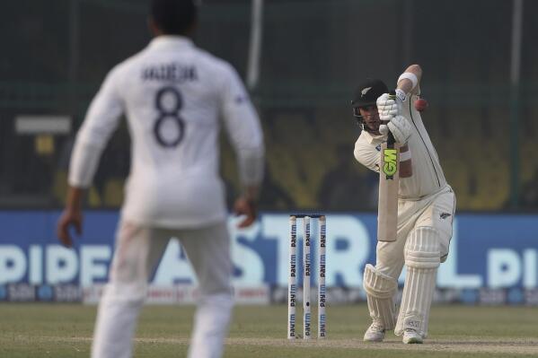 New Zealand's Will Young plays a shot during the day two of their first test cricket match with India in Kanpur, India, Friday, Nov. 26, 2021. (AP Photo/Altaf Qadri)