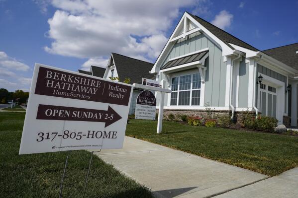 FILE - An open house is posted in front of a home for sale in Westfield, Ind., Sept. 25, 2020. Sales of previously occupied U.S. homes ticked higher in October, marking their strongest pace since January, even as resilient demand and competition for relatively few properties on the market kept prices climbing. The National Association of Realtors said Monday, Nov. 22, 2021 that existing homes sales rose 0.8% last month from September to a seasonally-adjusted annual rate of 6.34 million units. (AP Photo/Michael Conroy, file)