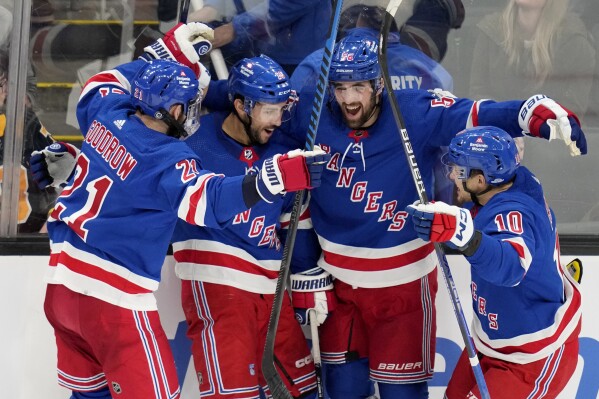 New York Rangers center Vincent Trocheck, second from left, celebrates after his game-winning goal off Boston Bruins goaltender Jeremy Swayman during an overtime period of an NHL hockey game, Saturday, Dec. 16, 2023, in Boston. (AP Photo/Charles Krupa)