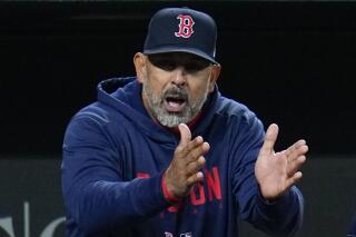 Boston Red Sox manager Alex Cora reacts from the dugout after Enrique Hernandez was called out on strikes during the ninth inning of a baseball game against the Baltimore Orioles, Monday, April 24, 2023, in Baltimore, Md. The Orioles won 5-4. (AP Photo/Julio Cortez)