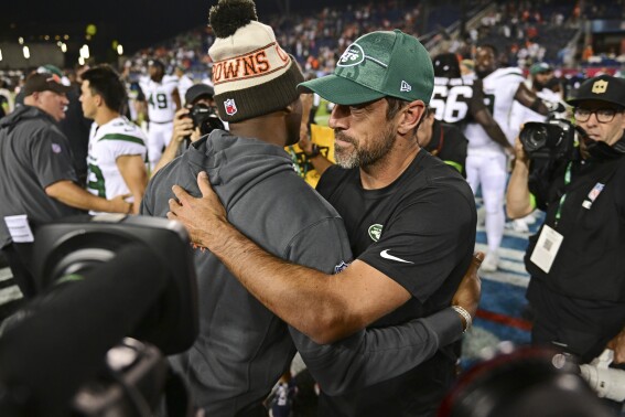 New York Jets quarterback Aaron Rodgers, right, and Cleveland Browns quarterback Deshaun Watson embrace following the Hall of Fame NFL football preseason game Thursday, Aug. 3, 2023, in Canton, Ohio. The Browns won 21-16. (AP Photo/David Dermer)