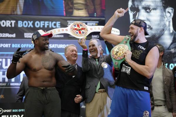 British heavyweight boxers Tyson Fury and Dillian Whyte pose as they take part in their weigh-in at the Boxpark Wembley venue, near Wembley Stadium, in London, Friday, April 22, 2022. Wembley Stadium will stage Tyson Fury's defense of the WBC heavyweight title against British countryman Dillian Whyte on Saturday. (AP Photo/Matt Dunham)
