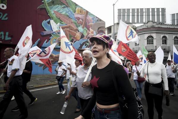 People march during a demonstration marking Martyrs' Day, a national day of mourning to honor the 21 Panamanians who were killed during the January 1964 anti-American riots over sovereignty of the Panama Canal Zone, in Panama City, Thursday, Jan. 9, 2025. (AP Photo/Agustin Herrera)