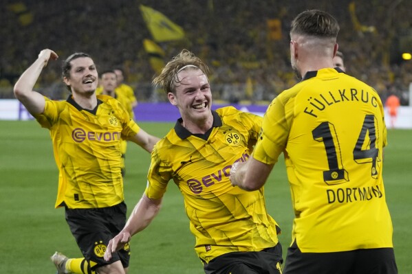 Dortmund's Niclas Fuellkrug, right, celebrates after scoring his side's opening goal during the Champions League semifinal first leg soccer match between Borussia Dortmund and Paris Saint-Germain at the Signal-Iduna Park stadium in Dortmund, Germany, Wednesday, May 1, 2024. (AP Photo/Matthias Schrader)