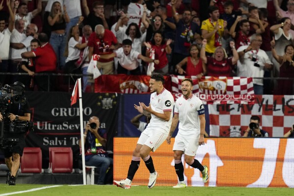 Sevilla's Lucas Ocampos celebrates scoring his side's first goal during the Champions League Group B soccer match between Sevilla and Lens at the Ramon Sanchez-Pizjuan in Seville, Spain, Wednesday. Sept. 20, 2023. (AP Photo/Jose Breton)
