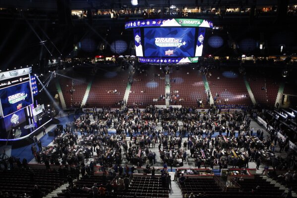 Teams, owners, coaches and other personnel get ready for the start of the second round of the NHL draft at Rogers Arena in Vancouver, British Columbia, Saturday, June 22, 2019. (Chad Hipolito/The Canadian Press via AP)