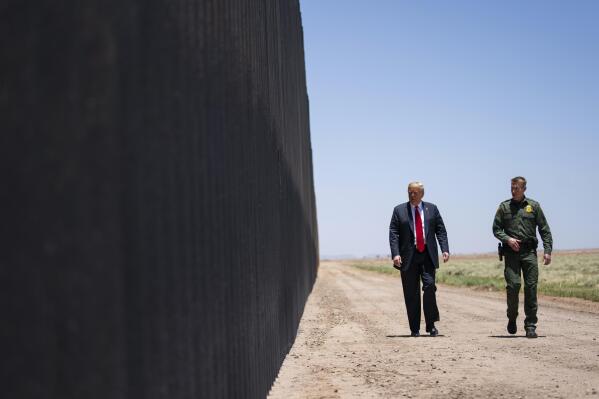 FILE - In this June 23, 2020, file photo, United State Border Patrol chief Rodney Scott gives President Donald Trump a tour of a section of the border wall in San Luis, Ariz. The chief of the Border Patrol said Wednesday, June 23, 2021, he was leaving his job after less than two years in a position that lies in the crosshairs of polarizing political debate. Scott wrote to agents that he will be reassigned. (AP Photo/Evan Vucci, File)